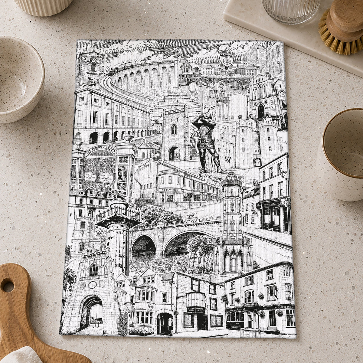 A rectangular kitchen towel with Alnwick Northumberland montage