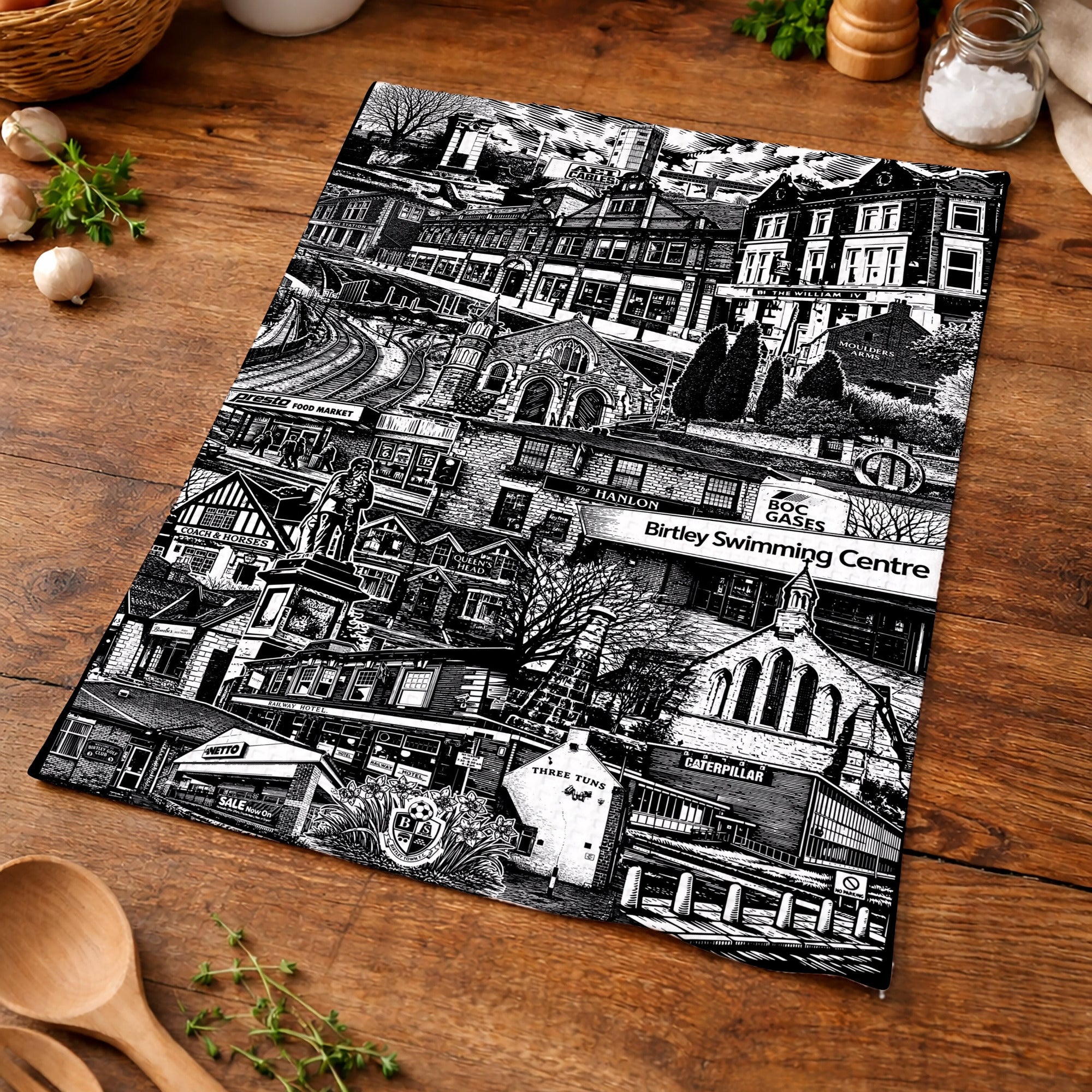 Black and white patterned placemat on a wooden table with kitchen items.