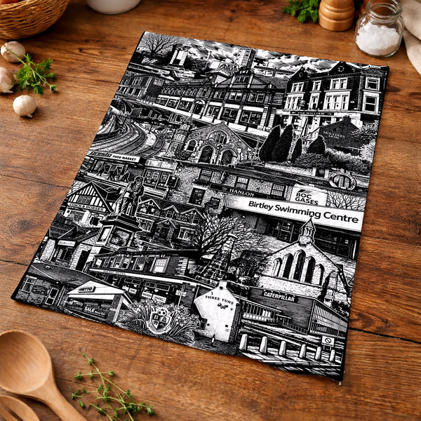 Black and white patterned placemat on a wooden table with kitchen items.
