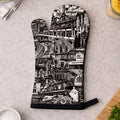 Oven mitt with black and white cityscape design on a kitchen counter.