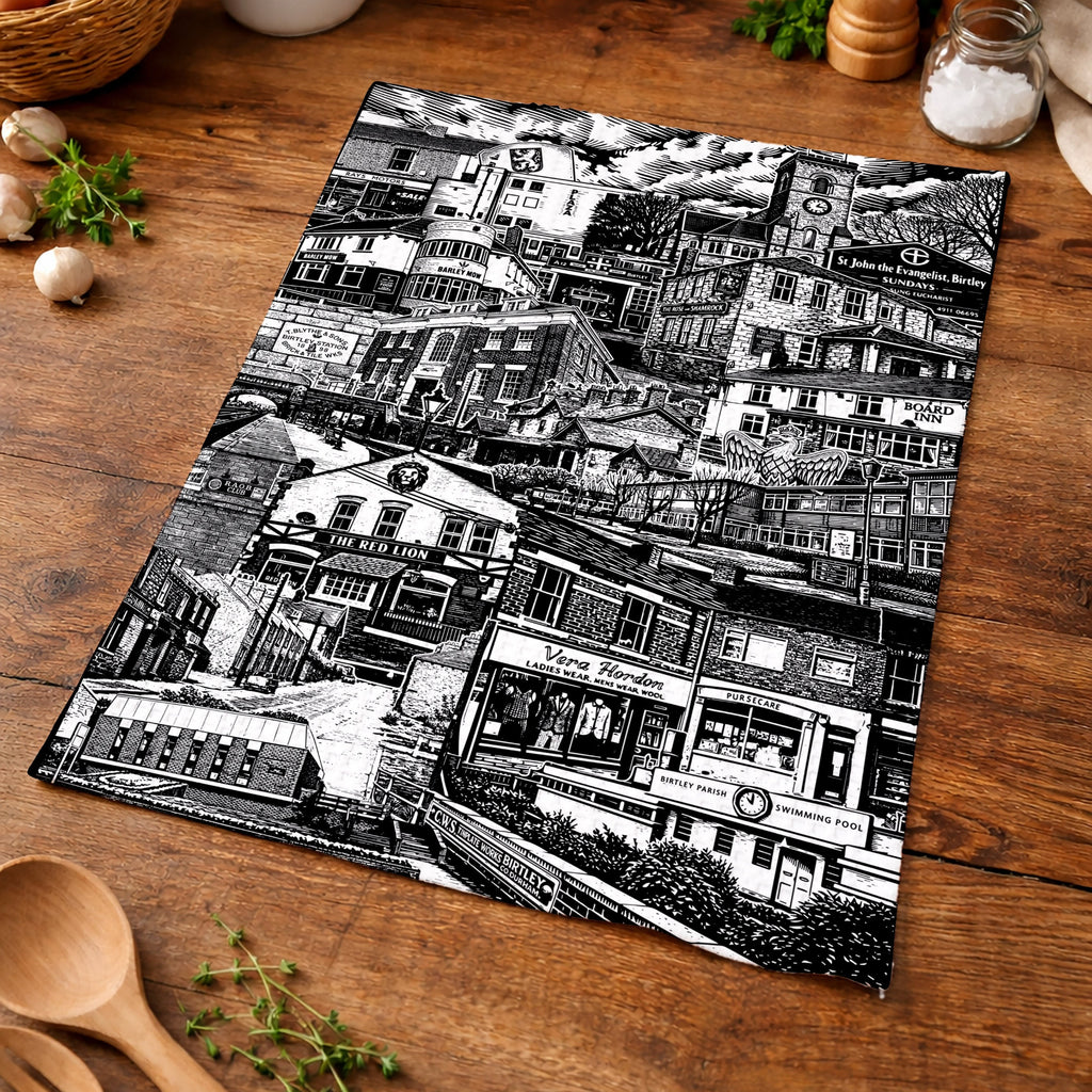 Black and white patterned placemat on a wooden surface with kitchen items.