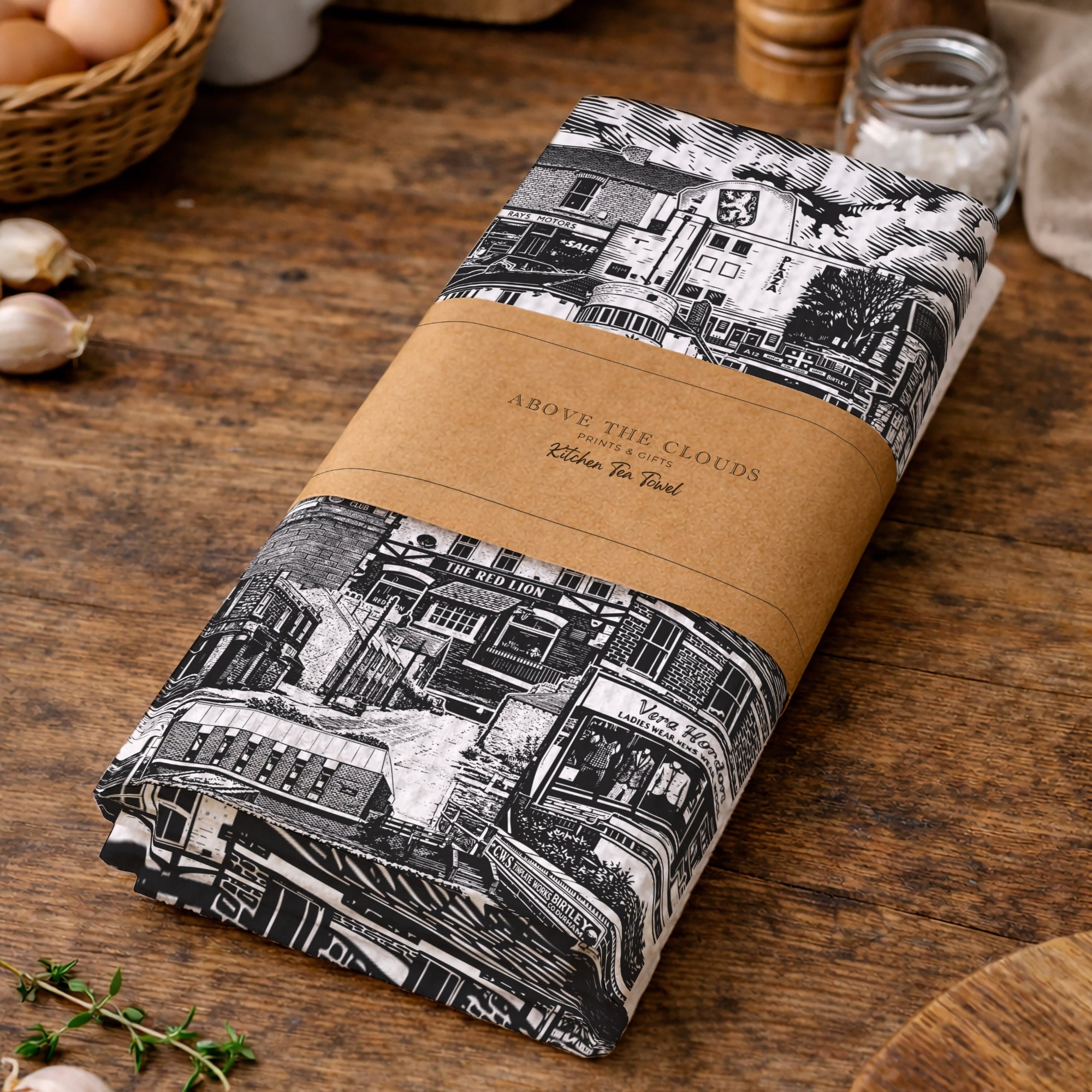 Roll of fabric with black and white pattern on a wooden surface