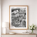 Framed black and white artwork of a cityscape on a wall above a console table with decorative items.
