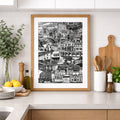 Framed black and white print on a kitchen wall with wooden cabinets and white countertops.