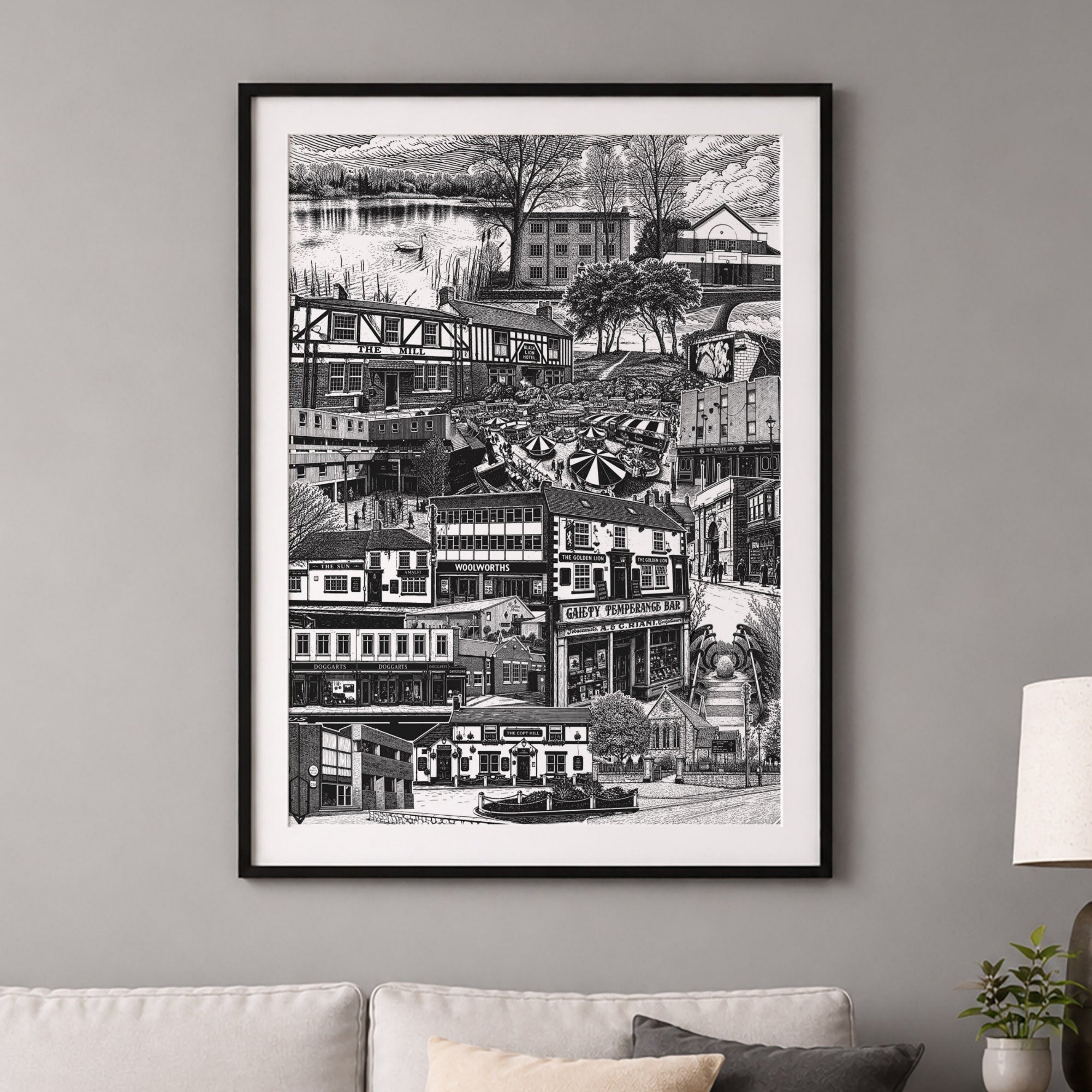 Framed black and white cityscape print on a gray wall above a sofa.