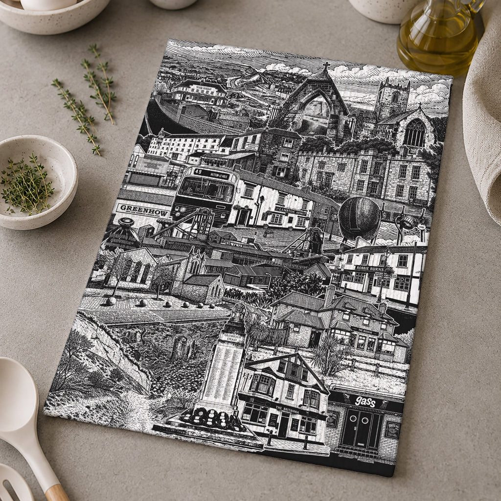 Black and white patterned placemat on a kitchen counter with utensils and ingredients.