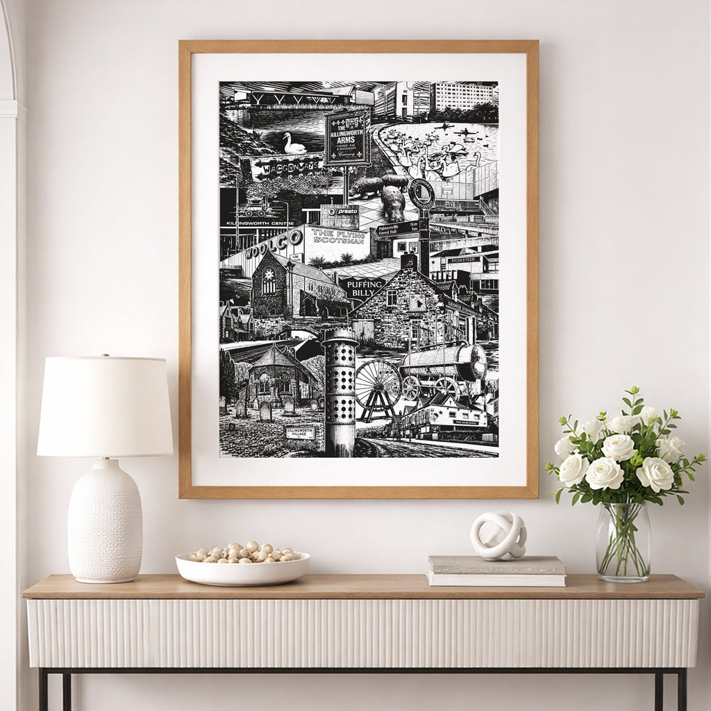 Framed black and white artwork on a wall above a console table with decorative items.