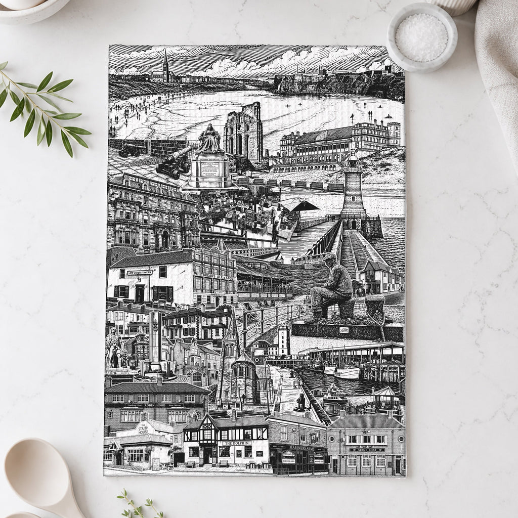 Black and white cityscape print on a kitchen counter with utensils and decor.