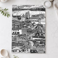 Black and white cityscape print on a kitchen counter with utensils and decor.