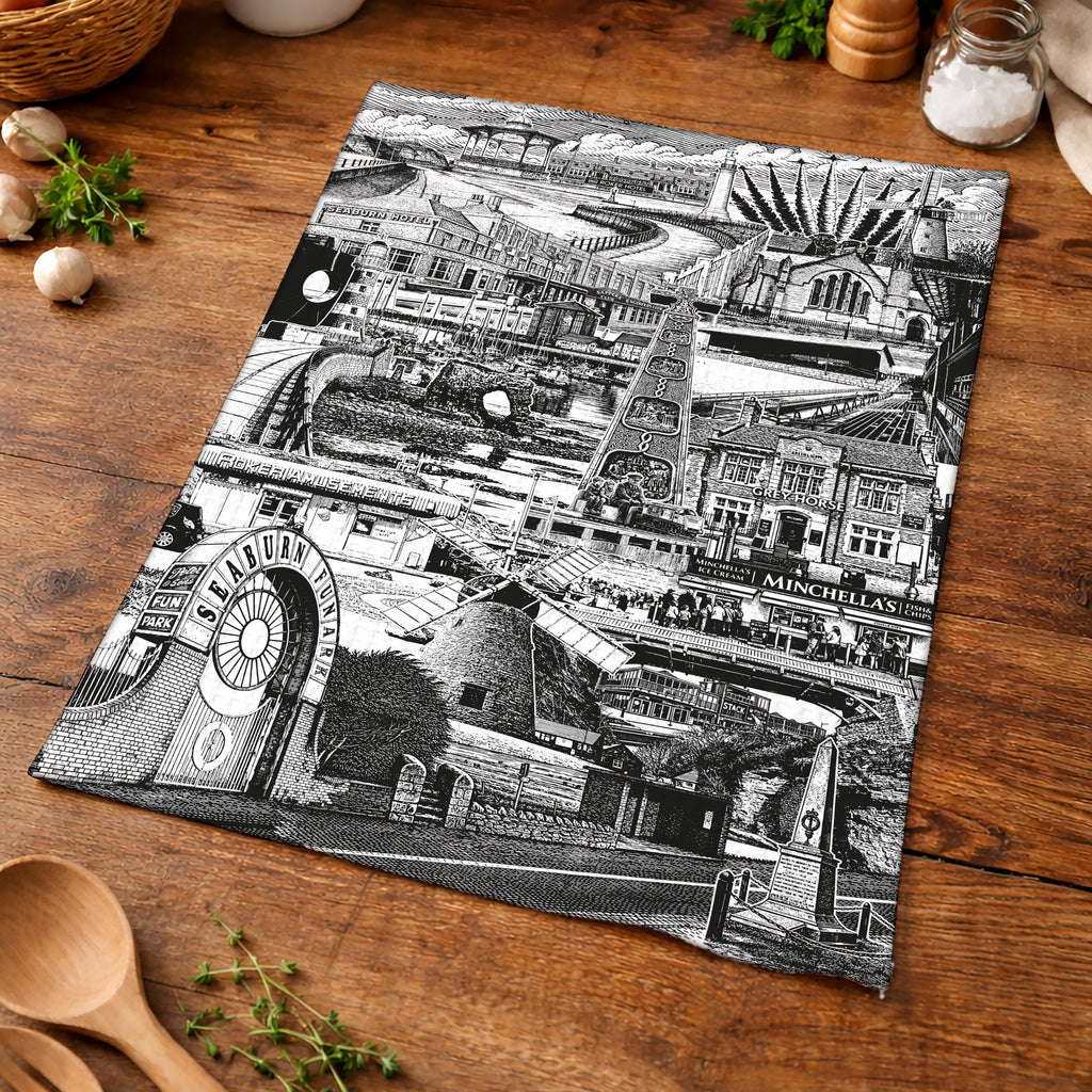 Black and white map of a town on a wooden surface with kitchen items.