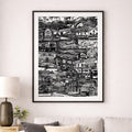 Framed black and white cityscape print on a wall above a sofa in a living room.