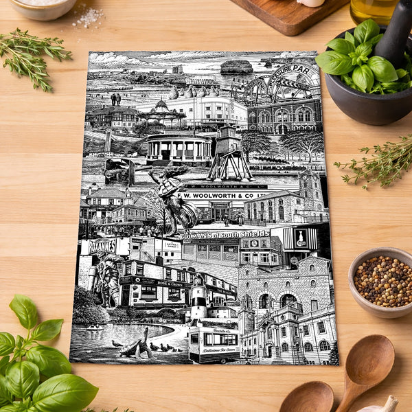 Black and white collage of city scenes on a wooden surface with kitchen items.