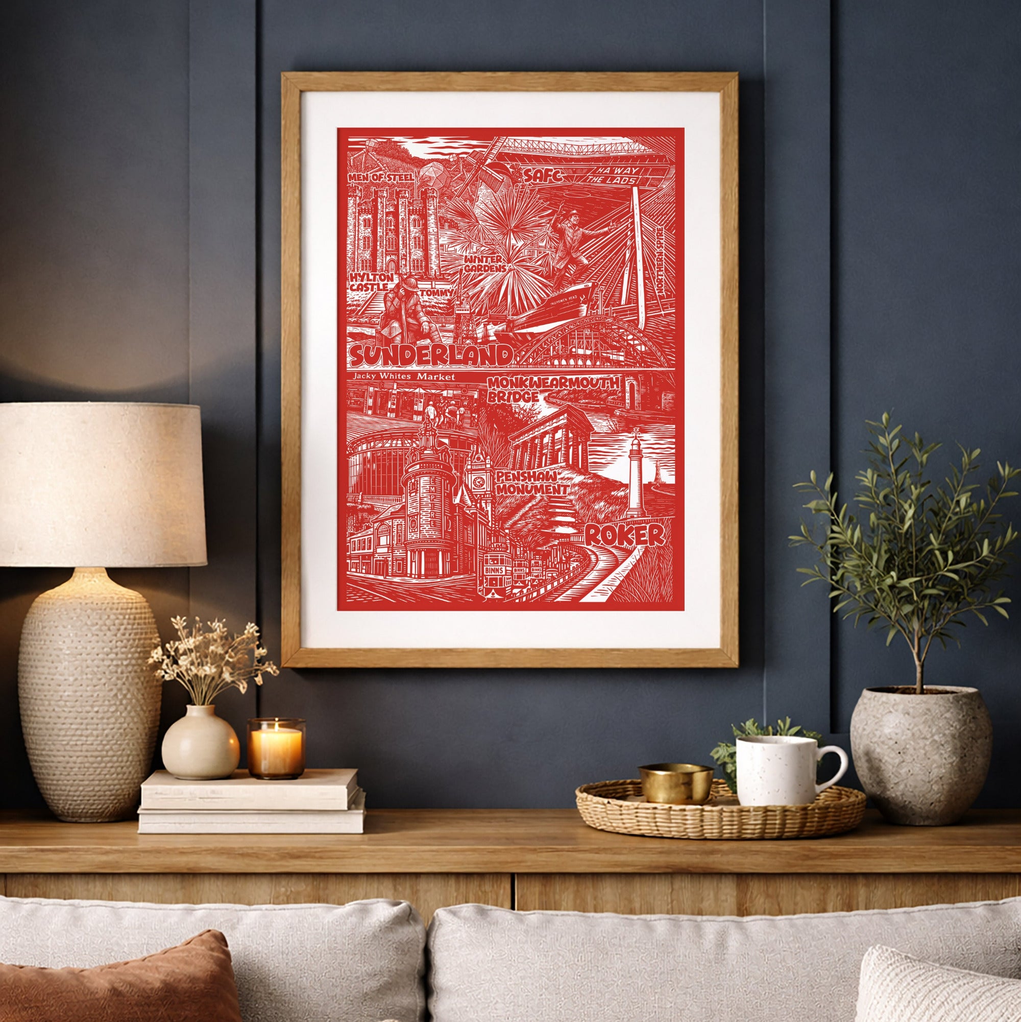 Living room with a red framed artwork on a dark blue wall, a gray sofa with pillows, and decorative items.