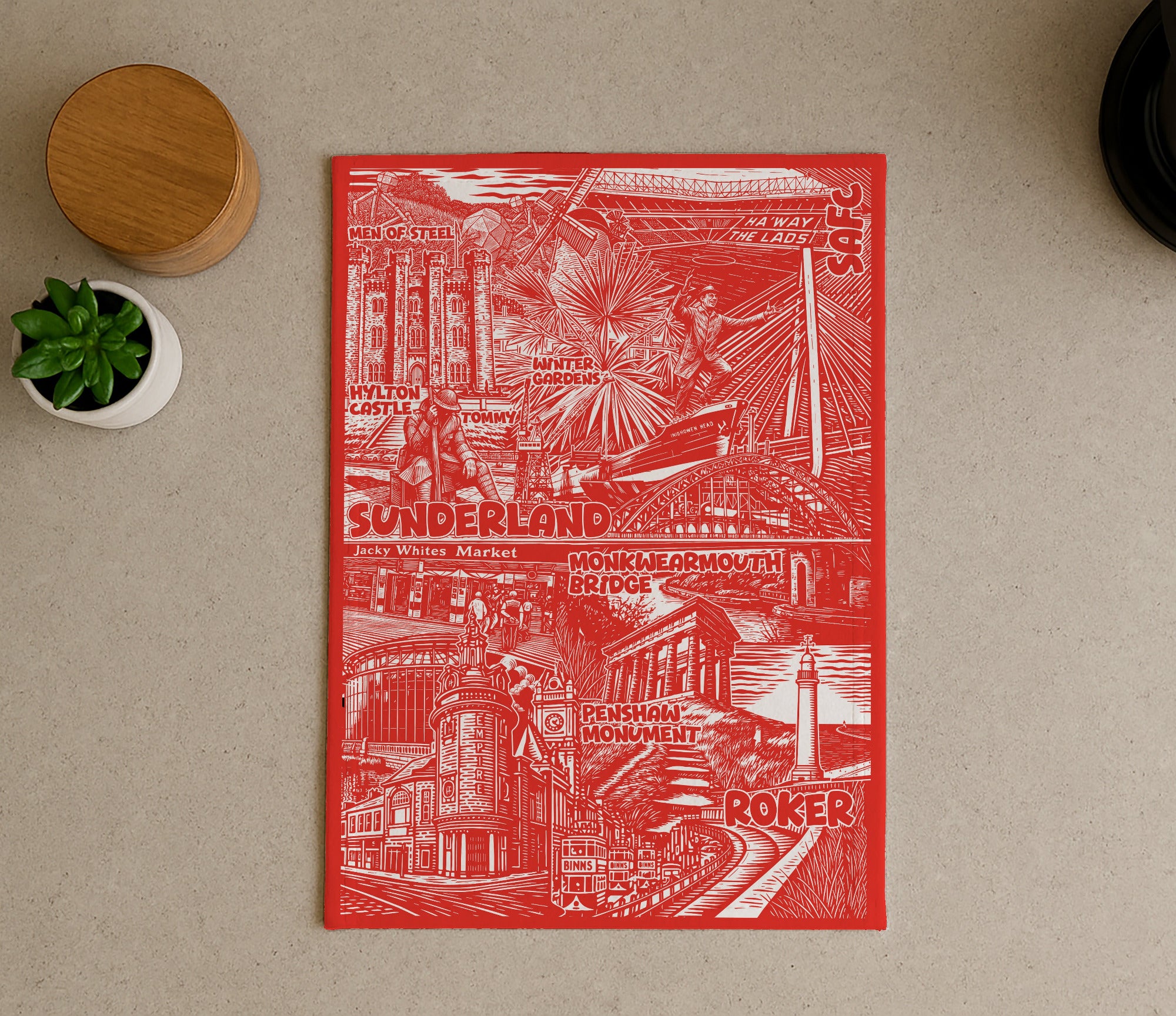 Red and white illustrated poster on a beige surface with a plant and wooden object.
