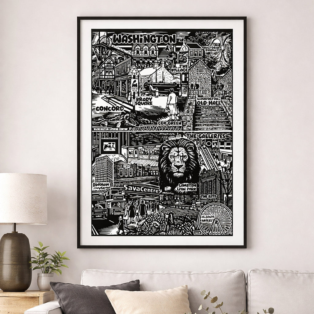 Framed black and white cityscape print on a wall above a sofa.